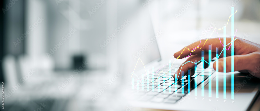Poster closeup of a person typing on a laptop keyboard with financial graphs overlayed, in a modern office 