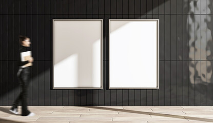 Empty vertical poster mockup on a black tiled wall with a young woman walking by holding a notepad.