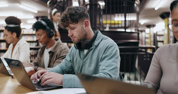 Research, typing and laptop with man in library for knowledge, education and college thesis. Academy, future and university portal with students and studying for exam, project and scholarship