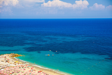 Fototapeta premium view from above on the beautiful sandy beach of bergeggi with the turquoise blue water of the mediterranean sea and sunshine