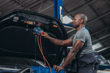 Professional Auto Technician Servicing Car Air Conditioning