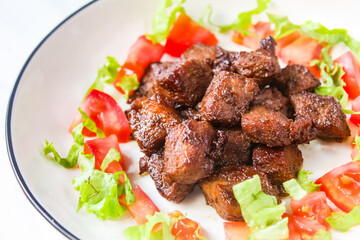 close-up of a plate of chopped beef steak with salad
