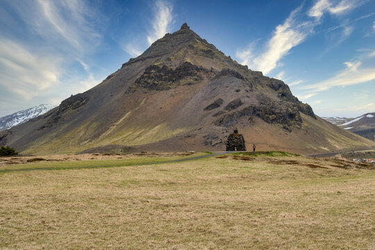 Bardur Snaefellsas Statue in front of a mountain, Anarstapi village, Snaefellsnes peninsula, Iceland