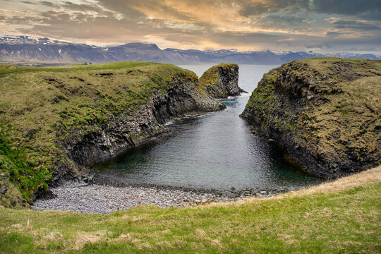 Coastal cliff landscape and mountainous coastline at sunset, Arnastapi, Snaefellsnes Peninsula, Iceland