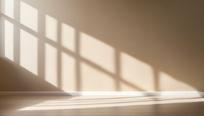 Fototapeta premium Light on the background wall. Shadow from the window and sunlight. White rays of the sun in a bright empty room. Shade overlay. Modern studio in beige tones. interior of a room with a window