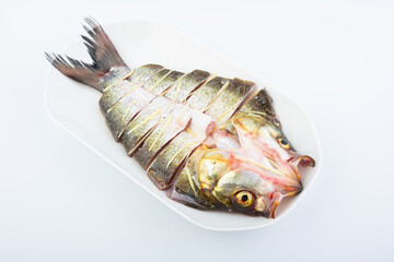 A fresh white fish on a plate