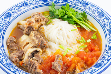 A bowl of tomato steak rice noodles