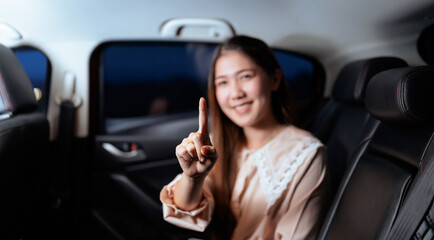 Beautiful asian woman sitting her new car happy smiling.