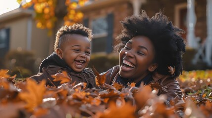 Obraz premium Mother and her child laughing as they jump into a big pile of colorful autumn leaves in their yard , family having fun celebrating the start of fall season