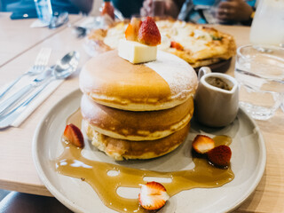 Breakfast pancakes with butter and strawberries