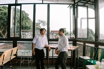 Fototapeta premium Two Southeast Asian men engaging in an enthusiastic conversation
