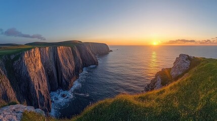 Fototapeta premium A panoramic view of a sunrise over a coastal cliff, with a clear sky for text placement.