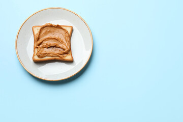 Delicious sandwich with peanut butter on light blue table, top view. Space for text