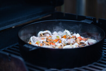 A delicious combination of vegetables and seafood on the BBQ, with rich, vibrant colours. Great for advertising BBQ equipment, gourmet cooking, or healthy grilling recipes.