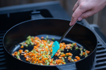 Brightly coloured vegetables and seafood grilling on the barbecue, offering a mouthwatering mix of flavors. Ideal for campaigns focused on BBQ events, cooking products, or summer dining.