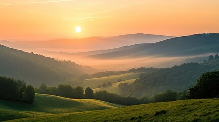 Fototapeta premium A sun rising over rolling hills with a soft-focus foreground, providing plenty of space for copy.