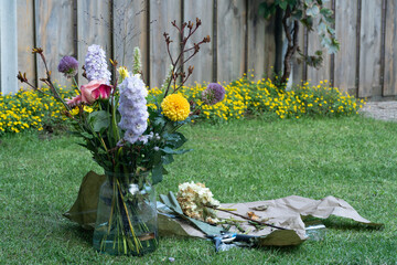 A beautiful floral workshop scene, where a florist is creating a decorative bouquet of fresh, colorful blooms. The workspace is filled with natural beauty.