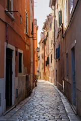 Charming cobblestone alleyway in Rovinj, Croatia, illuminated by the warm glow of evening light
