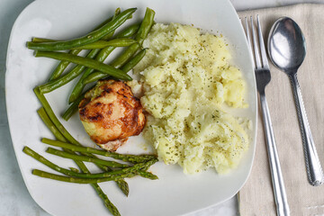 barbecue chicken thigh with asparagus and green  beans.
