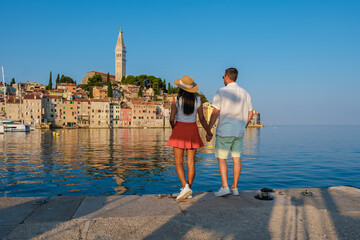 Couple enjoying a romantic evening by the waterfront in Rovinj, Croatia with stunning seaside views