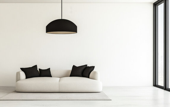 Modern minimalist living room with a light sofa, black pillows, and a striking pendant light against a spacious white wall