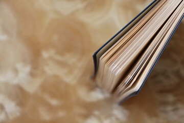 Navy blue cover notebook standing upright on marble floor. Top view