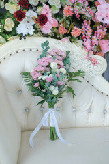 Wedding bouquet. Beautiful multi colored fresh flower arrangements. wedding day. The bride and groom were photographed on the sofa.