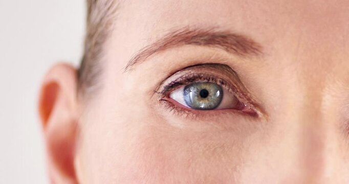 Antiaging, eye and skincare with mature woman closeup in studio for cosmetic beauty treatment. Face, special effects and zoom with wrinkles of person on white background for collagen or dermatology