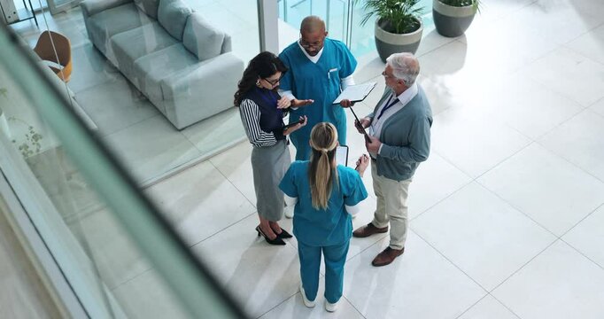Man, doctors and discussion in lobby at clinic for paperwork, tablet and above for healthcare service. Hospital director, staff and team in scrum for meeting with diversity, feedback or collaboration