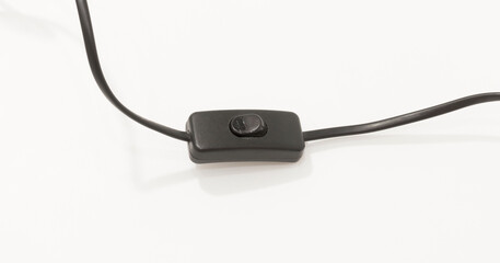 Black inline rocker switch on cable, isolated against white background, suitable for electronic device controls.