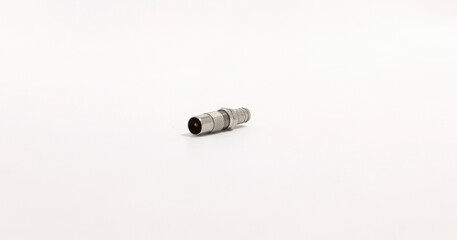 Close up of metallic connector on plain background, ideal for technology or hardware related themes.