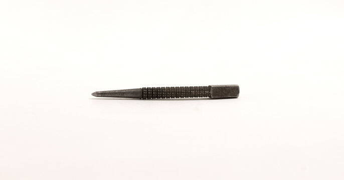 Small metal center punch tool with textured grip, used for marking metal or woodworking.