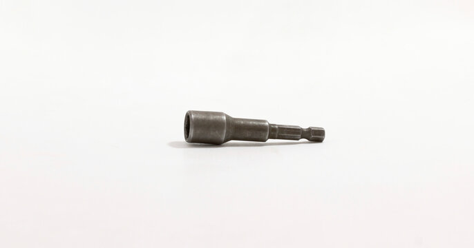 Metal socket adapter for drill bits on plain white background, showcasing simplicity and industrial utility.