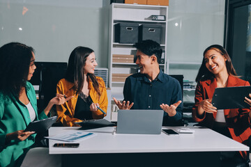 Young corporate employees sitting in office looking at laptop screen reading good news excited happy team diverse people celebrating victory win command success excellent result professional teamwork