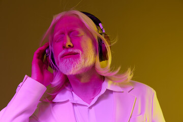 Portrait of a man with long white hair wearing headphones, lost in music, set against a vibrant yellow and purple background, conveying a sense of peace and enjoyment