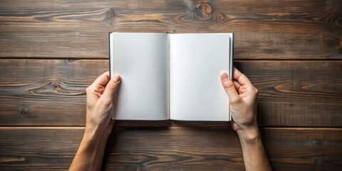 Symmetrical Open Book Concept Holding Blank Pages in Hands on Wooden Surface Minimalist Reading Mockup Idea