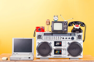 Radio cassette tape recorder boombox, retro TV, golden microphone, old telephone, outdated notepad,...