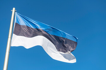 Flag of Estonia flying in the wind with a blue sky background...country, land, eesti, estonian