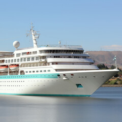 A beautiful multilevel resort liner sails through the waves during the day