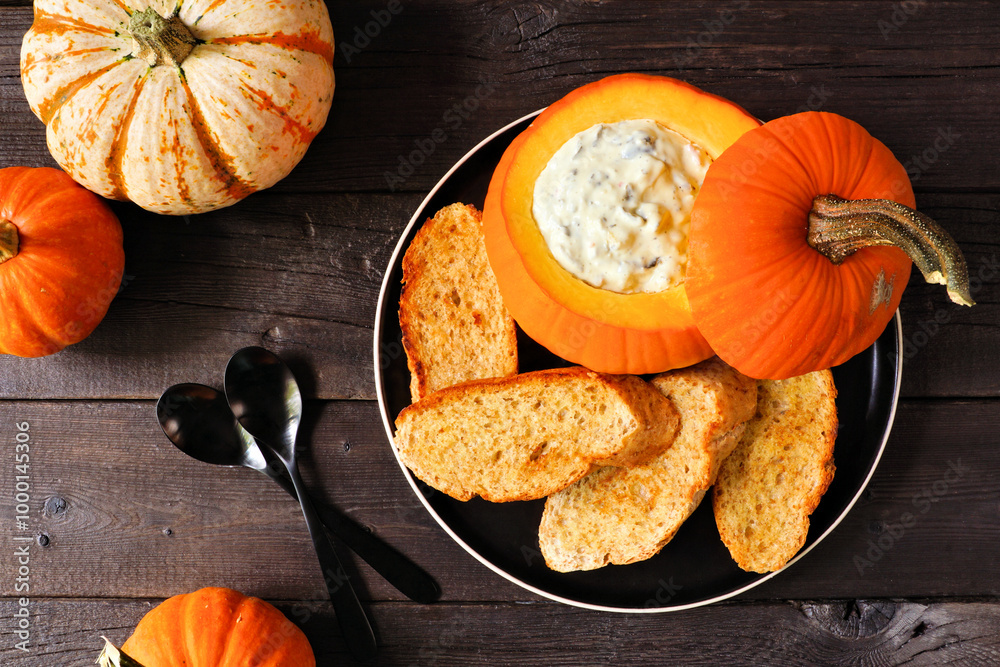Aufkleber fall pumpkin theme appetizer with spinach dip and toasted baguettes. top down view table scene again