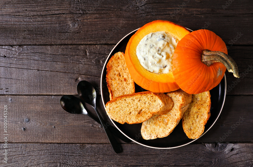 Aufkleber autumn pumpkin theme appetizer with spinach dip and toasted baguettes. overhead view against a dark 