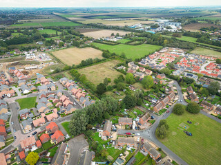 Aerial view of two sprawling new housing developments seen between a parcel of land which maybe ear...