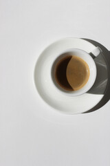 Freshly Made Espresso Shot with Crema Foam on White Background. Drinking Morning Coffee.