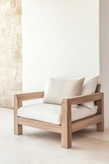 Modern wooden lounge chair with neutral cushions placed against a minimalist stone wall in a bright interior space
