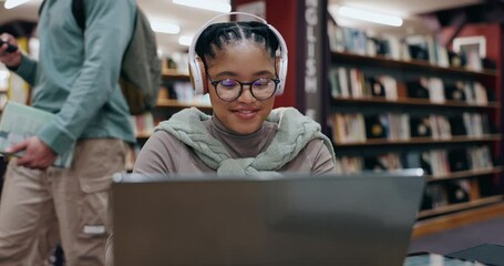 Girl, student and headphones with laptop in library for assignment essay, study music and exam research. University, african person and happy with technology for online course, dancing and education