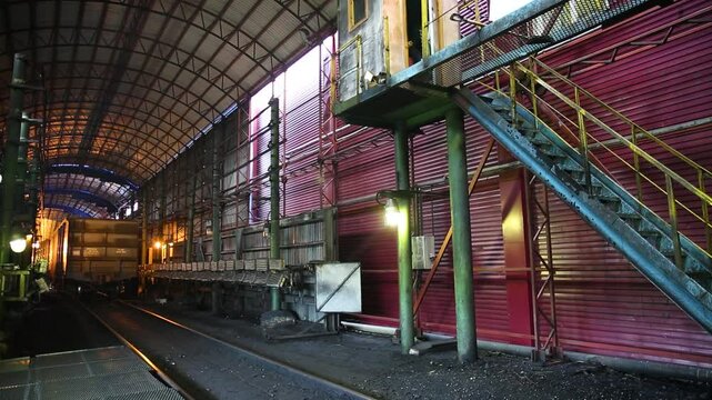 An industrial interior setting featuring striking metal stairs alongside various types of machinery
