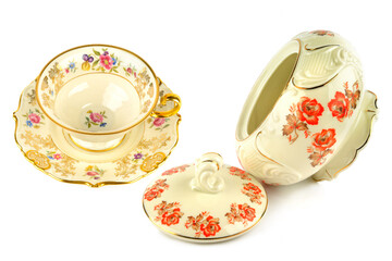 Vintage porcelain tableware: coffee cup with saucer and elegant candy bowl isolated on white. Collage.