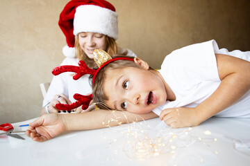 Merry Christmas Happy New Year Children in family are preparing for new year and having fun on table
