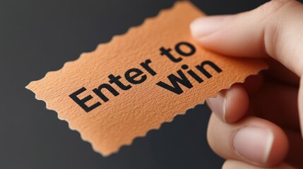 A person holds an orange ticket with Enter to Win printed on it, indicating a chance to win a prize or contest