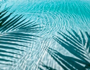 Top view of a blue calm and clear calm water surface, water texture with ripples and palm trees shadow